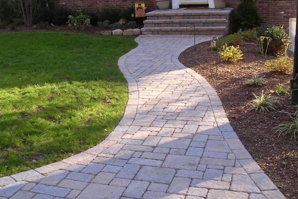 Paver walkway with landscaping along a home entrance