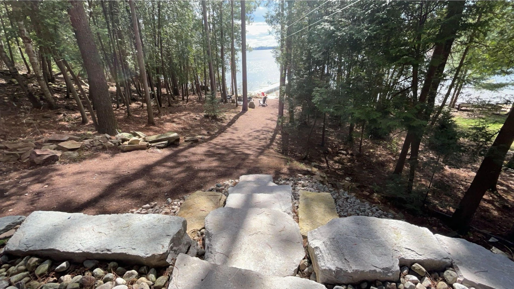 Natural stone steps leading down a wooded path